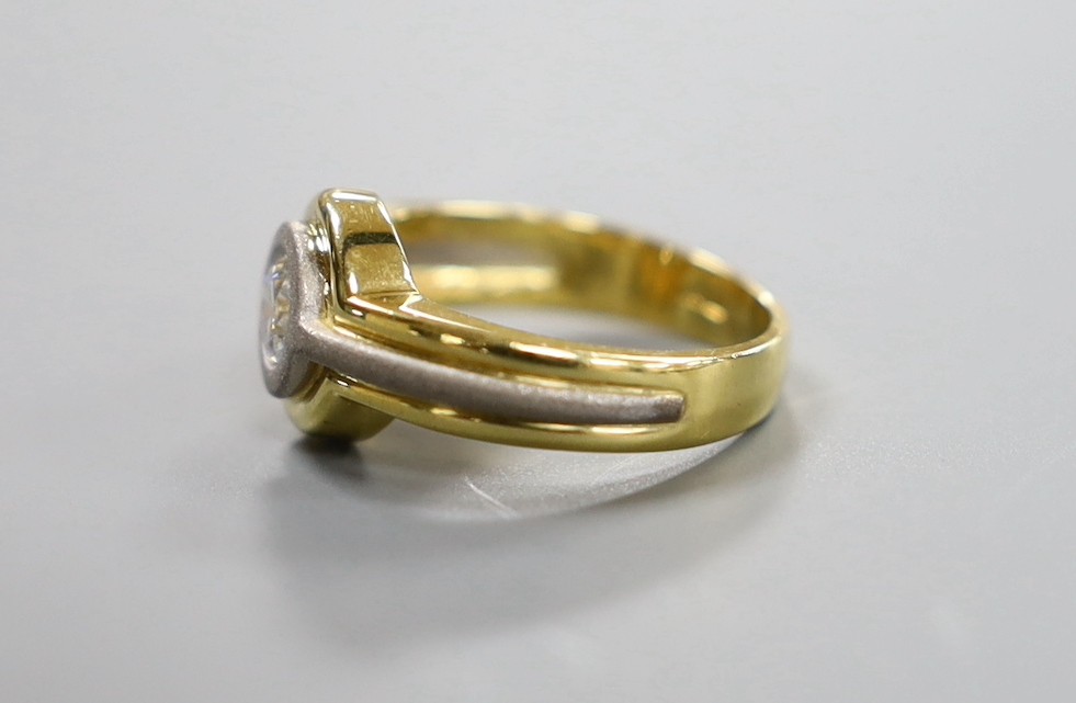 A modern 18ct two colour gold and solitaire diamond set ring, with sand blasted band, size L, gross weight 6.2 grams